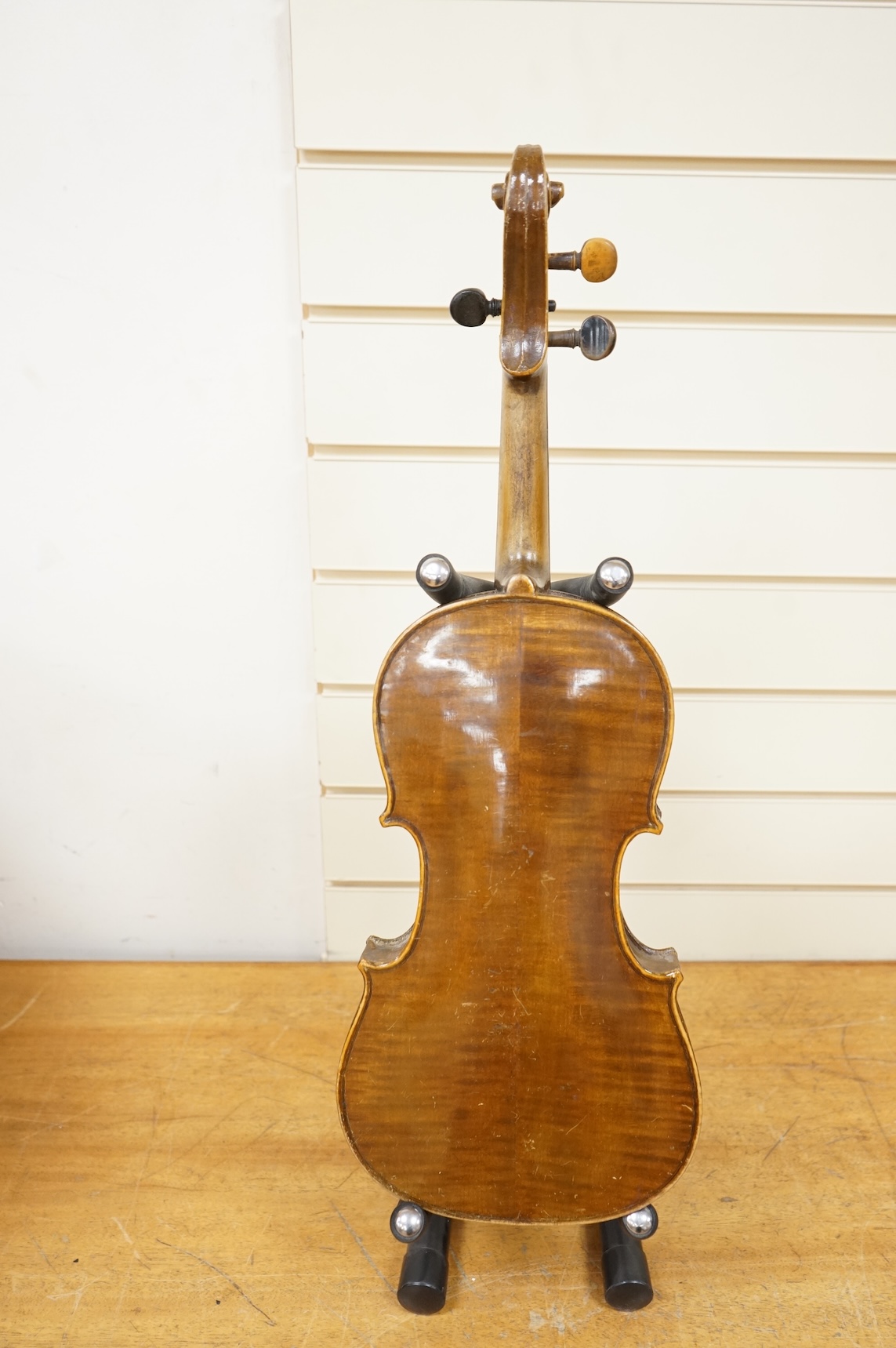 Four violins; a German Dresden violin, together with further two German violins, and a Saxony violin, three in cases or the remains of cases.